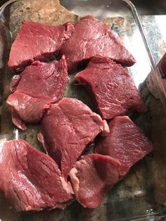 raw meat sitting in a glass dish on top of a counter