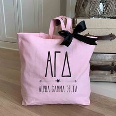 Alpha Gamma Delta sorority name custom printed on pink canvas tote bag Pink Canvas Tote Bag, Bid Day Gifts, Sigma Delta Tau, Fabric Panel Quilts, Pink Tote Bag, Delta Phi Epsilon, Alpha Sigma Alpha, Bleach Product, Black Bow Tie