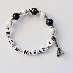 a bracelet with beads and charms that say i love you to the eiffel tower