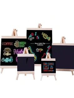 three eases with neon signs on them in front of a white background and one has a blackboard