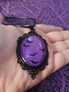 This gothic/victorian style necklace features a black frame and a purple interior. The bats appear to be flying. Perfect necklace for anyone who loves gothic jewlery! The pendant lays on a black waxed adjustable necklace cord and is 20" long. 2.48"×1.46" *size is approximate* *one sided* Gothic Purple Necklace For Halloween, Gothic Purple Jewelry For Halloween, Bat Pendant, Hex Girls, Bat Necklace, Purple Interior, Gothic Victorian, Necklace Cord, Victorian Gothic