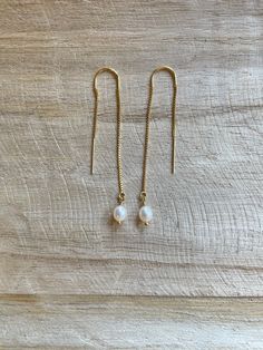 "These long threader earrings are a beautiful combination of petite pearls and gold filled dainty chain.  Enjoy giving these earrings as a gift, for a wedding or pairing them with your favorite new outfit! -2 3/8\" Freshwater pearl dangles  -White Freshwater rice round pearls (4-5mm) -Gold Filled Dainty Box Chain Threader Ear wire  ---These are perfect for brides and bridesmaids! Bulk order available upon request! 💗 Gold Minimalist Dainty Pearl Threader Earring | Simple Pearl Bridal Earring | L Delicate 14k Gold Filled Threader Earrings, Delicate Gold Linear Earrings With Pearl Drop, Delicate 14k Gold Filled Linear Earrings For Everyday, Minimalist Pearl Drop Threader Earrings, Dainty 14k Gold Filled Linear Earrings For Everyday, Dainty 14k Gold Filled Earrings, Minimalist Gold Pearl Threader Earrings, Dainty Linear Earrings With Pearl Charm For Gift, Delicate 14k Gold Filled Earrings With Pearl Chain