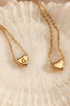 Share the love with our mini heart initial necklace. It can be worn two ways. Initial letter is on one side of the heart, the other side is plain. Makes a great gift. Think family, friends, teachers and more! You can gift their first name initial, last name initial, spouse initial, and more! Perfect for you and perfect as a gift! Details: Extender that can lengthen or shorten the necklace as desired Stainless steel - gold plated Heart Initial Necklace, Mini Heart, First Name, Initial Letter, Initial Letters, Share The Love, Initial Necklace, The Other Side, First Names