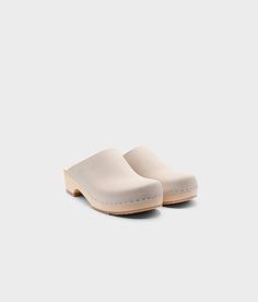 Elevate your everyday style with our minimalist clog mule, featuring clean lines and a timeless aesthetic that effortlessly transitions from day to night. Clog measurements:Heel height: 1 3/4” (4.5 cm)Toe height: 1 5/8″ (4.1 cm) Fit:RegularLeather:Nubuck leather Clogs consist of:Base: European Lime Wood Sole: Rubber sole Fastening: Staples Cork Sandals, Wooden Clogs, Timeless Aesthetic, Clog Sandals, Leather Clogs, Day To Night, To Night, Nubuck Leather, Boot Shop