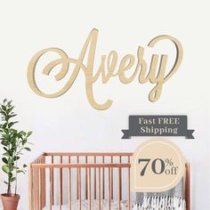 a baby crib next to a wall with the word avery on it