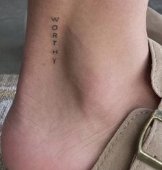 a woman's foot with the word worry written on her left side ribcage