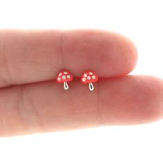 A sweet and simple pair of Mushroom stud earrings in sterling silver. Earrings are made of 925 silver and size 5mm x 6mm. The earrings have red and white epoxy detailing on the cap. These earrings are great for those with sensitive ears. Mix and match with my other stud earrings Includes sterling silver earring backs. This listing is for one pair (2 pieces). Tiny Mushroom, Cartilage Stud, Dainty Earrings, Earrings Photo, Earring Backs, Minimalist Earrings, Sterling Silver Earrings, 925 Silver, Red And White