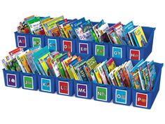 a blue bin filled with lots of books on top of each other and alphabets