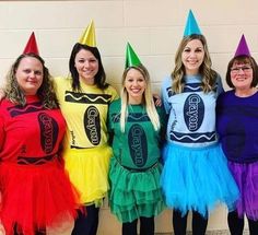 four girls in colorful costumes standing next to each other