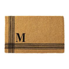 a door mat with the letter m in black and white stripes on it's front