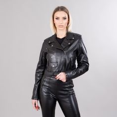 Short leather jacket in black color.  This short jacket has zipped exterior side pockets, a collar, a belt, and a zipper closure.  The garment will stand out with its unique pattern and warmth.  The jacket manufactures in our company in Greece with high-quality lambskin. Leather: Lamb Color: Black Length: 45-50 cm (17,7-19,6 in) Collar: Yes Exterior pockets: Yes Belt: Yes Lining: 100% Polyester Care: Specialist clean Long Sleeve Leather Jacket For Biker Events, Modern Biker Jacket With Asymmetrical Zip For Winter, Punk Biker Jacket With Long Sleeves And Zip Fly, Black Leather Jacket With Zip Fly For Fall, Modern Black Leather Jacket With Long Sleeves, Black Punk Leather Jacket With Zipper, Winter Leather Jacket For Biker Events, Black Leather Jacket With Long Sleeves And Front Zipper, Black Leather Jacket With Zip Fly And Long Sleeves