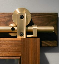 a close up of a wooden door with a metal handle on the front and side