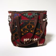 KILIM HANDMADE SHOULDER Bag is a unique handmade product woven on Anatolian carpet and kilim looms. The leather parts are made of genuine leather and the inner parts are made of high quality waterproof fabric. It has two 25x25 cm (9.8x9.8 inches) zippered compartements on both sides and 20x15 (7,9x6 inches) zippered compartment inside. Can be used as handbag and shoulder bag. Its large interior volume has the capacity to meet your daily needs. This bag is a part of a carpet which weaved in somew Bohemian Bag, Shoulder Bag Vintage, Bohemian Bags, Bag Vintage, Handmade Kilim, Waterproof Fabric, Laptop Bag, Purses And Handbags, Tote Bags