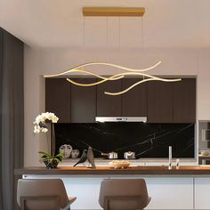 modern kitchen with black and white marble countertops, wooden cabinets and bar stools