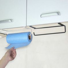 a hand holding a roll of blue toilet paper