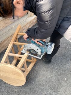 a person using a circular saw to cut wood