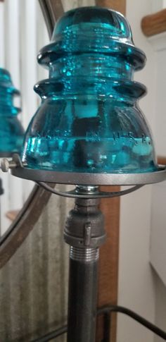 a blue glass lamp sitting on top of a table