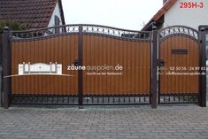 an iron gate with wooden panels on the side