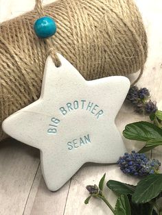 a ceramic star ornament with the words brother sem on it next to twine of twine