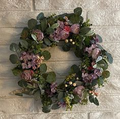 a wreath is hanging on a brick wall