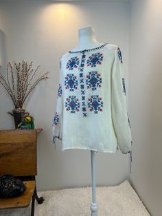 Vintage  Hungarian Blouse / Hungarian Blouse / vintage embroidered blouse / Hungarian embroidery  This is a Hungarian blouse with gorgeous embroidery down the front and along the length of each sleeve. Her neckline and cuffs are trimmed in thread for extra appeal. She is gorgeous, comfortable and light. A perfect warm weather or travel blouse.  Measurements provided are flat and have been doubled. Bust 42" Waist 42" Length 25" ❤️ Condition: Great vintage condition. Flaw: I found two tiny spot on the front hem. I am going to try and treat them and update this listing. For now, Please see photos of these tiny flaws. This item has been cleaned and is ready to wear. $148 includes domestic shipping and insurance. International shipping is $30. Please let me know if you have questions, would lik Folk Style Embroidered Long Sleeve Peasant Top, Embroidered Long Sleeve Folk Peasant Top, Folk Style Long Sleeve Top With Resham Embroidery, Folk Style Embroidered Peasant Top, Folk Style Long Sleeve Peasant Top With Intricate Embroidery, Folk Style Peasant Top With Intricate Embroidery, Vintage Embroidered Peasant Top For Festival, Folk Style Peasant Top With Multicolor Geometric Embroidery, Traditional Embroidered Long Sleeve Peasant Top