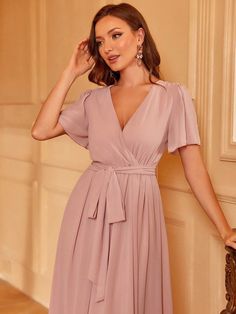 Product Code: FSWD1406 Embellishment: Chiffon Fabric: 100% Polyester Back Style: Zipper Up Fully Lined: Yes Built-in Bra: No Available Color: Pink Stretch: Moderate Fits true to size Imported Model Information: Height: 5' 2" Bust: 33.5'' Waist: 24“ Hips: 35.5” wearing US size Small Feminine Evening Chiffon Dress With V-neck, Chiffon V-neck Cocktail Dress, Fitted V-neck Chiffon Dress In Feminine Style, V-neck Chiffon Midi Dress For Cocktail, Fitted Chiffon V-neck Dress, Chiffon V-neck Dress For Wedding Guest, Formal V-neck Chiffon Mini Dress, Feminine V-neck Chiffon Dress For Evening, Feminine V-neck Bridesmaid Midi Dress