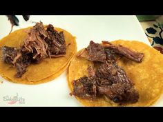 two tortillas with meat on them sitting on a plate