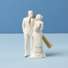 a wedding cake topper with a bride and groom figurine