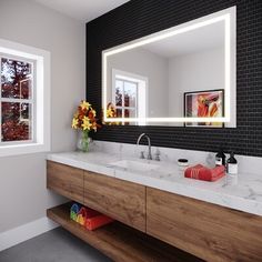 a bathroom with two sinks and a large mirror over it's counter top,