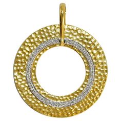 18k yellow gold and 14k white gold diamond circle pendant. The large yellow gold piece is stamped 18k, 750, and tests 74% gold with an XRF analyzer. The white gold test is between 54% to 56% gold. The diamonds are round brilliant cuts, .40 total carats, H to i color, Vs to Si clarity. The widest part of the pendant measures about 1 1/2 inches wide. Excellent condition.