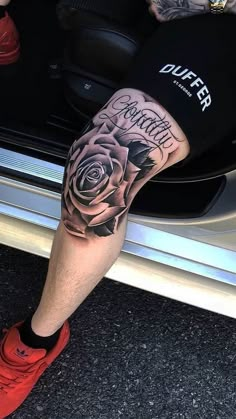 a man with a rose tattoo on his leg