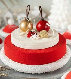 there is a red and white cake with gold decorations on it