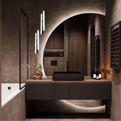 a bathroom with a sink, mirror and bathtub in the center is lit by lights