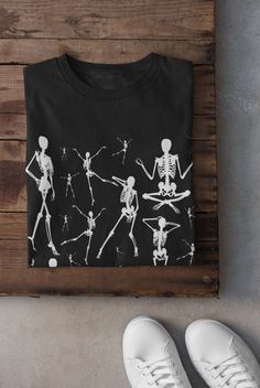 Thanks for stopping by! Skeletons T-shirt Printed on a super soft, cotton tee Dispatched in 5 working days or sooner Unisex Free UK delivery Material: 100% ringspun cotton. Chest (to fit): S  34/36   M  38   L  40/42   XL  44/46   XXL  48/50 ECO-FRIENDLY Each garment is made to order, reducing extra material and energy that would be otherwise wasted We use DTG printing process which is easier on the environment than screen-printing Our ink is bright and also eco-friendly. Do not tumble dry. Wash Black Emo T-shirt For Halloween, Black Grunge T-shirt For Fall, Gothic Skull Print T-shirt For Fall, Edgy Halloween T-shirt For Alternative Fashion, Gothic Black T-shirt For Halloween, Black Punk T-shirt For Fall, Black Emo T-shirt For Fall, Punk Style Black Top For Halloween, Punk Black T-shirt With Skull Print