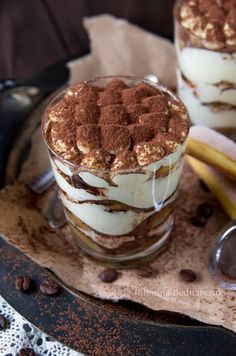 two desserts are sitting on a plate with chocolate chips and bananas around the edges