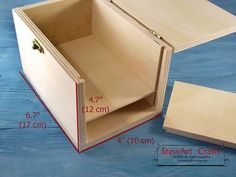 an open wooden box with measurements for the bottom and side opening to it on a blue surface