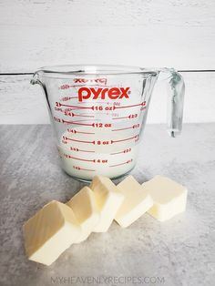 cubes of butter sit next to a measuring cup