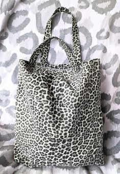 This handmade tote bag is made from upcycled fabric which makes it the perfect eco-friendly gift! This animal print bag is durable, and perfect for everyday use. It's great for carrying books and would make the perfect gift for those who love to read. Print: Leopard Size:  13" x 14.5", with 19" handles Everyday Upcycled Tote Canvas Bag, Everyday Upcycled Canvas Tote Bag, Leopard Print Tote, Upcycled Fabric, Handmade Tote, Tote Bags Handmade, Eco Friendly Gifts, Book Bag, Print Tote