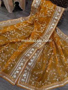 Mustard organza dupatta with gold embroidery jaal and sequins border. Cheap Zari Work Dupatta For Celebration, Luxury Yellow Tissue Silk Dupatta, Festival Anarkali Set In Dola Silk With Gold Embroidery, Elegant Gold Embroidery Dupatta For Festivals, Festival Anarkali Set With Gold Embroidery On Dola Silk, Elegant Gold Embroidered Dupatta For Festivals, Gold Anarkali Set With Intricate Embroidery For Festivals, Yellow Chinon Dupatta With Intricate Embroidery, Traditional Tissue Silk Wear With Gold Embroidery