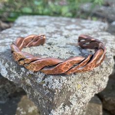 A larger and heavier version of our most popular bracelet. Artsy yet rugged, this unique, hand forged, pure copper bracelet was made for those who appreciate the raw and natural properties of copper. Different gauge wire was combined and formed before forging and peening. Burrs are carefully removed and sharp edges filed by hand before final sanding to maintain an antiqued patina. Copper is annealed to provide the user a bracelet that is strong yet soft enough to bend to a comfortable fit. Finis Unique Hammered Copper Bracelets, Hand Forged Copper Bangle Bracelet, Bronze Electroformed Metal Bracelet, Handmade Copper Bangle Bracelets, Artisan Bronze Copper Cuff Bracelet, Handmade Rustic Copper Cuff Bracelet, Adjustable Rustic Copper Bracelets, Adjustable Rustic Copper Bracelet, Handmade Rustic Bronze Bracelets