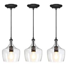 three glass pendant lights hanging from a ceiling