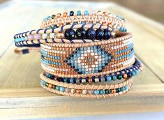 a stack of bracelets sitting on top of a wooden table