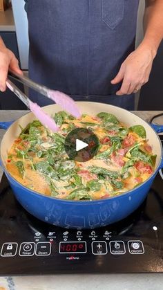 a person cooking food on top of a stove with a spatula in their hand