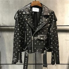 Heavy duty, black, soft genuine leather biker motorcycle style jacket with silver heart stud rivets all over. Features a zip-up collar, front zip pockets, and zippers on sleeve wrists. Poly satin lined with a belted waist for a relaxed, boxy fit. Perfect for adding an edgy touch to any outfit. Pair with jeans and boots for a classic biker look or layer over a dress for a chic, rebellious twist. Sizes by waist in inches. Painting Denim, Biker Chick Style, Womens Biker Jacket, Leather Rivets, Leather Jacket Style, Black Tweed, Motorcycle Style, Genuine Leather Jackets, Street Outfit