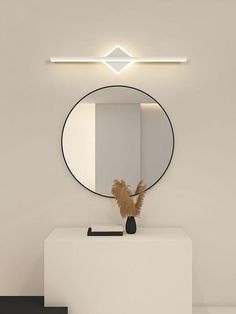 a mirror on the wall above a white counter