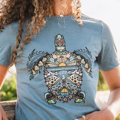 "Boho" is short for Bohemian, which embodies the free spirit of this eclectic, tribal inspired sea turtle design. The elements within are inspired by our natural world and the simplicity, yet made to be intricate and complex. Tap into your bohemian side with this Boho Sea Turtle women's T-Shirt. Support the parks with this women's Boho Sea Turtle shirt. Free shipping on orders more than $100. RELAXED FIT. Bohemian Short Sleeve Beach T-shirt, Blue Bohemian T-shirt For Summer, Bohemian Blue T-shirt For Summer, Blue Bohemian Cotton T-shirt, Bohemian T-shirt For Beach With Short Sleeves, Bohemian Beach Tops With Graphic Print, Bohemian Graphic Print Beach Tops, Bohemian Short Sleeve T-shirt For Beach, Bohemian Crew Neck Beach Top