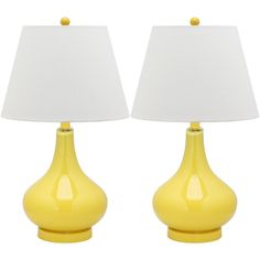 two yellow lamps sitting next to each other