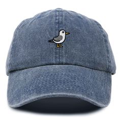 Embrace coastal charm with our Seagull Dad Cap, adding a touch of whimsy and seaside allure to your ensemble. Discover the perfect blend of style and comfort with our classic dad cap, tailored to fit effortlessly into your everyday wardrobe. This timeless hat features a convenient adjustable slider at the back, ensuring a customizable fit for all head sizes. Designed with functionality in mind, the cap includes eyelet holes for enhanced breathability, keeping you cool and comfortable throughout Brimmed Dad Hat For Summer Beach, Blue Baseball Cap For Beach, Cotton Brimmed Dad Hat For Beach, Adjustable Nautical Hats For The Beach, Adjustable Nautical Beach Hat, Blue Coastal Hat With Curved Brim, Blue Coastal Style Hat With Curved Brim, Casual Embroidered Sun Hat For The Beach, Casual Embroidered Sun Hat For Beach