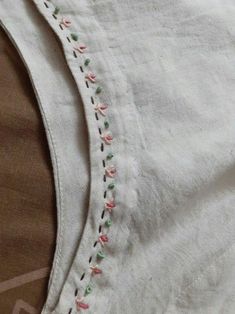 an embroidered piece of cloth with stitching on it's side and the bottom