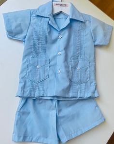 A summer version of a classic guayabera. These 2 piece baby blue guayabera set is great for the summer events. A perfect blend of elegance and comfort, includes a traditional shirt and a short with an elastic waist to keep your baby happy :) and for easy diaper changes.  Perfect for photo shoots, baptisms, weddings or any special events. Free Domestic Shipping for USA only. International Shipping Available at customers cost Via Usps International with tracking service. Please note for International Shipping, depending on your country you may or may not be require to pay Import Taxes. https://www.etsy.com/listing/1262927020/boy-guayabera-set-in-baby-blue-or-white Check our store for more : https://www.etsy.com/shop/FredandAliBoutique?ref=seller-platform-mcnav  message me for Rush order Solid Color Short Sleeve Short Set For Summer, Blue Summer Sets With Pockets, Blue Summer Set With Pockets, Summer Blue Sets With Pockets, Light Blue Summer Vacation Sets, Collared Summer Sets With Pockets, Summer Collared Sets With Pockets, Blue Collared Sets With Pockets, Blue Short Sleeve Sets With Pockets